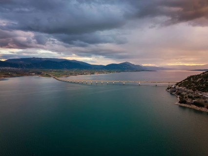 A stunning aerial view of Lake Polyfyto with the Servia Neraida high bridge spanning the water.