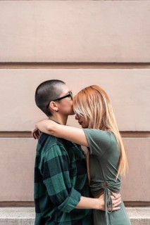 A tender moment between a Colombian lesbian couple, reflecting love and inclusivity. Embracing