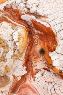 This striking aerial image captures the complex patterns of red and white rock formations. The