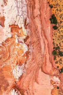Stunning top-down view of intricate red and white rock patterns in a desert landscape, showcasing