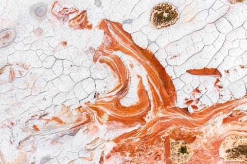 This stunning aerial photograph captures the intricate details of abstract red and white rock