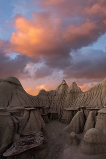 Surreal landscape at sunset featuring the unique hoodoos of Bisti/De-Na-Zin Wilderness in New
