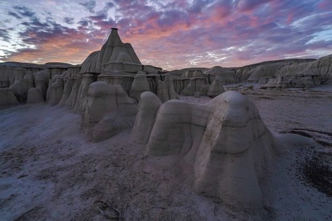 Dramatic sunset illuminating the unique rock formations of Bisti/De-Na-Zin Wilderness in New