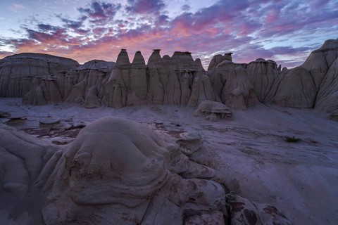 Stunning sunset illuminating the eroded sandstone formations in the Bisti/De-Na-Zin Wilderness,