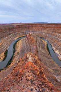 Stunning aerial view of a San Juan canyon featuring a winding river carving through layered rock