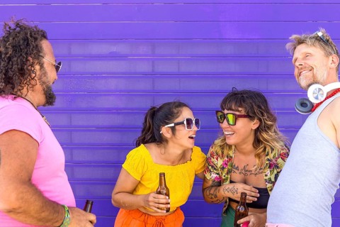 A joyful group of LGBTQIA+ friends gathers, sharing laughter and embracing diversity, symbolizing