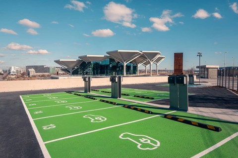 View of a new transport hub in Valdebebas, Madrid, featuring parking with electric vehicle charging