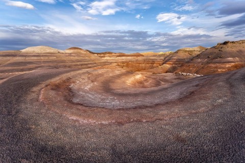 Dramatic aerial view of Hanksville Bentonite Hills in Utah, showcasing colorful, layered rock
