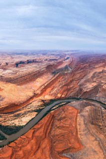 Captivating aerial view of a sprawling San Juan canyon with layered rock formations and a