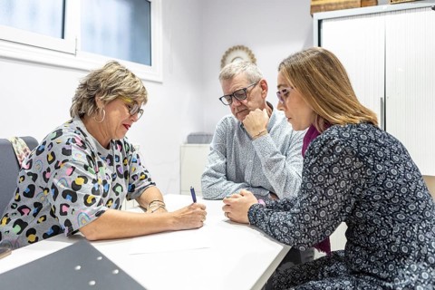 A couple with intellectual disabilities engaged in a focused supervision meeting. They are