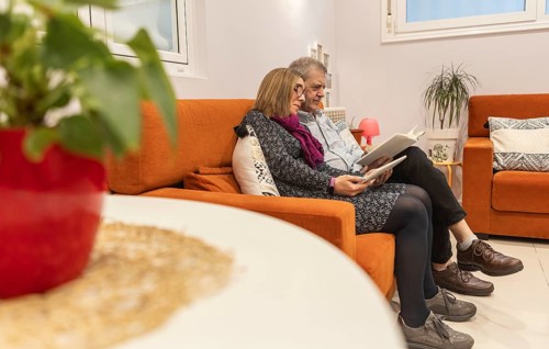A couple with intellectual disabilities enjoys a relaxed time together in a supervised home,
