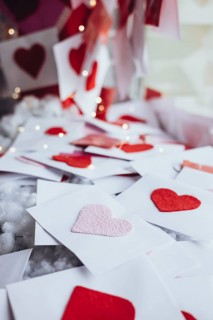 A romantic scene with Valentine's Day letters adorned with felt hearts. Soft lighting highlights