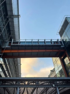 A dynamic view of London Heathrow airport architecture showcasing metal and glass structures. The