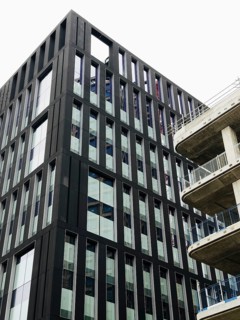 A striking modern building in London showcasing sleek lines and geometric patterns against a clear