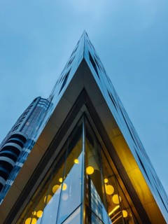 A striking view of a modern glass building in London's skyline, showcasing sharp angles and