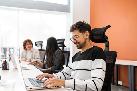 A vibrant office scene displaying coworkers engaged in teamwork, emphasizing collaboration and