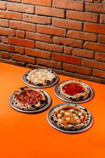 A mouthwatering assortment of pizzas featuring Margherita, Pepperoni, Four Meats, and Four Cheese.