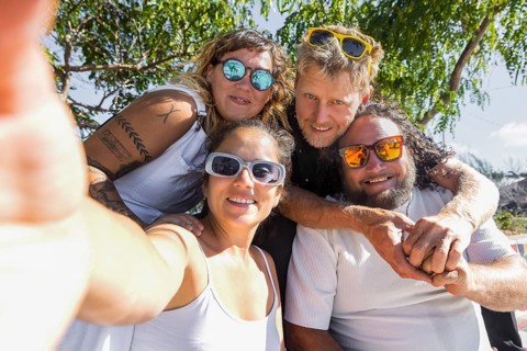A cheerful group of LGBTQIA+ couples enjoying a sunny day outdoors. Their happy expressions and