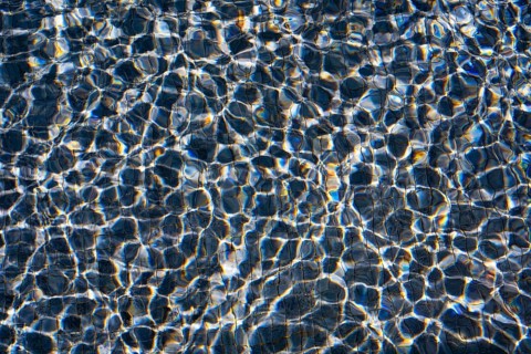 Sunlight dances on the rippling waters of Playa Blanca Port, Lanzarote, creating a mesmerizing