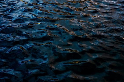 Dark and moody water textures captured at Playa Blanca Port in Lanzarote. Intricate light