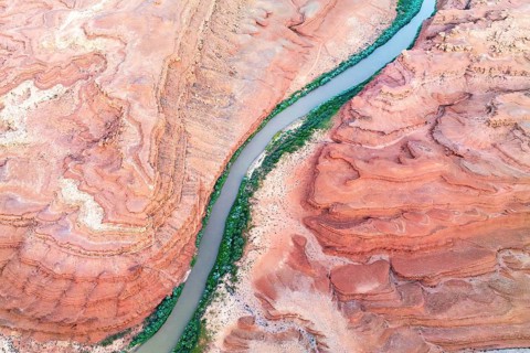 A stunning aerial shot of the Rio San Juan river weaving through the layered red rock formations in