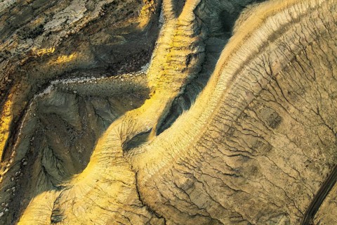 A stunning aerial capture of the golden sandstone formations in Utah, USA. The intricate patterns