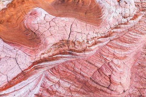 Discover the striking abstract formations and vibrant colors of desert rock textures at Vermilion