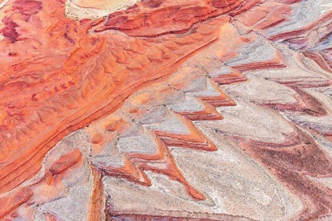 Striking aerial photograph showcases intricate, colorful rock formations surrounding the San Juan