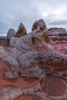 Striking rock formations characterized by intricate patterns and a mix of red and white sandstone