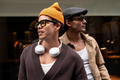 A Colombian gay couple enjoying a relaxed moment together. They wear fashionable clothes,