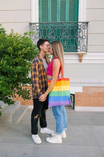 A happy lesbian couple shares a tender moment outdoors, celebrating their love and pride. One