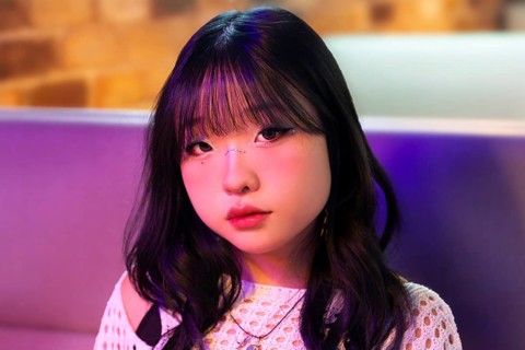 Portrait of an Asian Gen Z girl enjoying the vibrant lights and atmosphere of an arcade Her