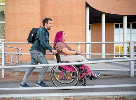 A couple at college exemplifies inclusion and accessibility The woman uses a wheelchair due to