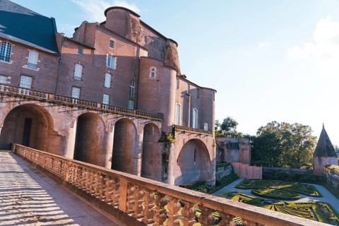 A stunning Berbie Palace exhibits grand architecture, with robust arches and detailed balconies in