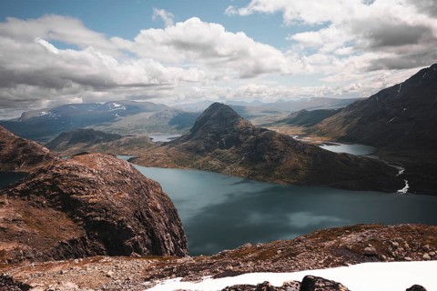 A stunning panoramic view of rugged mountain peaks and pristine lakes in Norway The dramatic
