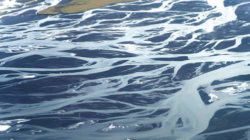 Stunning aerial photograph showcasing the intricate patterns and textures of meandering rivers