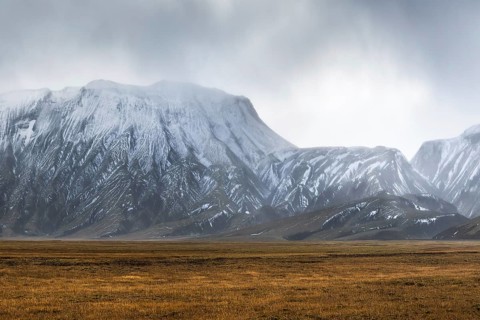 Captivating landscape of the Icelandic Highlands featuring rugged, snow-capped mountains under