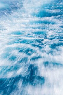 Blurred water effect creating a sense of speed and movement. The light reflections add a vibrant