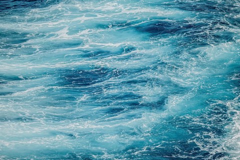 Calm water surface with soft ripples and shades of blue. A peaceful and serene moment of nature