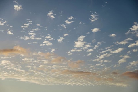 Soft scattered clouds in the sky during dusk. The pastel colors create a dreamy and tranquil