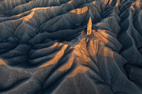 A striking aerial view of the textured terrain of Caineville Mesa near Hanksville, Utah, bathed in