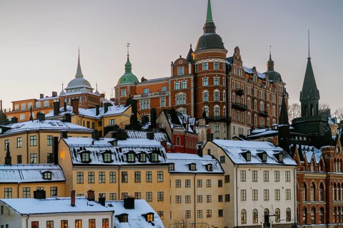 Discover the stunning architecture of Stockholm, Sweden, as the winter sun sets over snow-covered