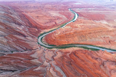 Aerial view of the serpentine Rio San Juan meandering through the stark red canyon landscapes of