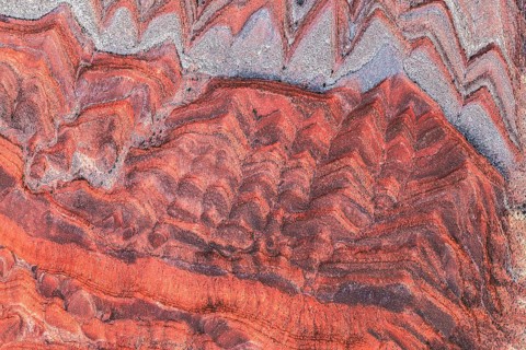 Striking aerial image capturing the rich, red and gray patterns of rock formations along the San