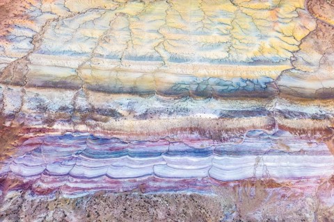 Explore the captivating textures of Vermilion Cliffs National Monument in Arizona. This aerial view