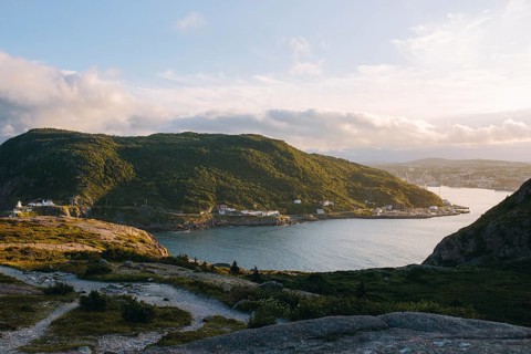 A serene view of Signal Hill, St. John's showcasing a sweeping coastline with a sunlit harbor