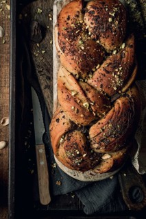 Top view of an artisanal chocolate and pistachio bakbah bread, beautifully presented on a dark