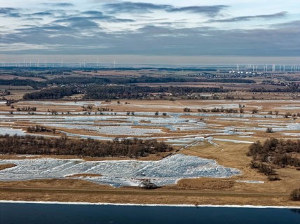 Ice and snow-covered foothills of the Oder in the Lower Oder Valley National Park. aerial view.