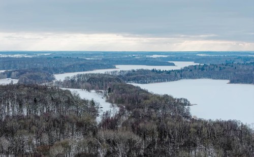 There is snow on the fields and lakes in the UNESCO Schaalsee Biosphere Reserve. aerial view.