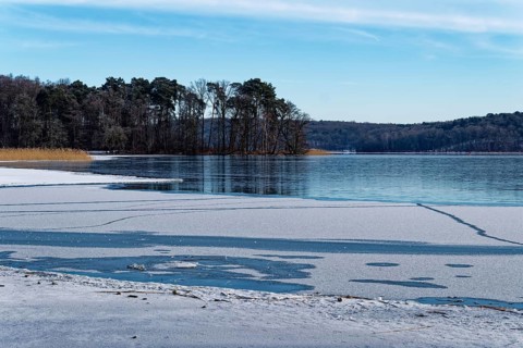 Snow on the shore and ice fields on Lake Werbellin in the UNESCO Schorfheide-Chorin Biosphere